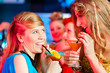 People in club or bar drinking cocktails