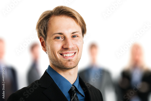 Photo: Businessman in front of his team Businessman in front of his team