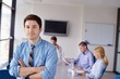 business man  on a meeting in offce with colleagues in backgroun