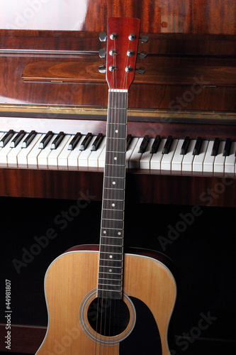 Photo: guitar neck on old piano keys guitar neck on old piano keys