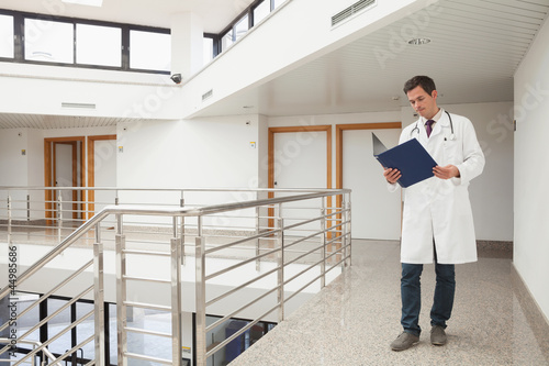 Photo: Doctor checking folder Doctor checking folder
