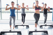 Photo: Four women lifting weights while doing aerobics Four women lifting weights while doing aerobics