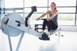 Woman training on row machine