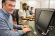 Photo: Smiling man sitting in front of the computer Smiling man sitting in front of the computer