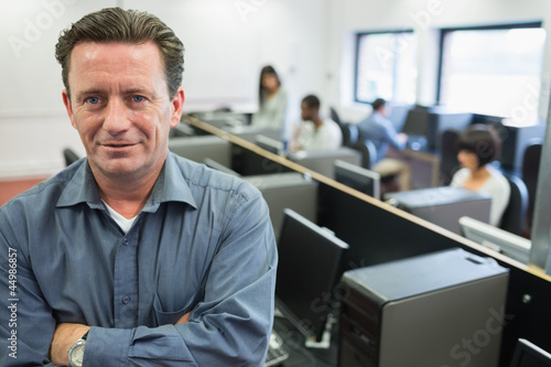 Photo: Man smiling at front of computer class Man smiling at front of computer class