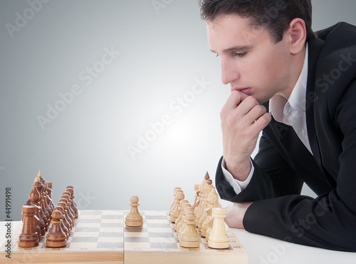 Photo: business man playing chess, making the move business man playing chess, making the move