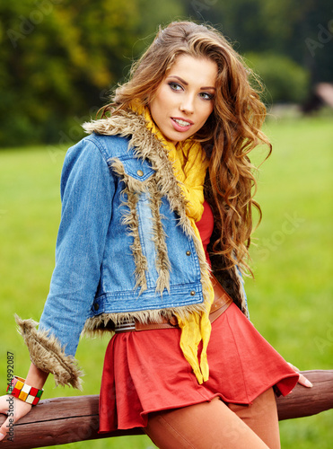 Photo: beautiful young woman in autumn park. beautiful young woman in autumn park.
