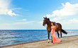 girl with horse on seacoast