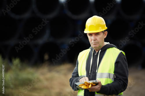 Photo: construction worker using digital tablet construction worker using digital tablet