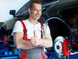 Motor mechanics in garage shows thumbs up after fixing a brake