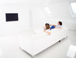 Couple watching tv at home