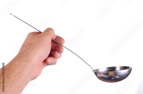 Photo: hand holds a soup ladle, isolated on white hand holds a soup ladle, isolated on white