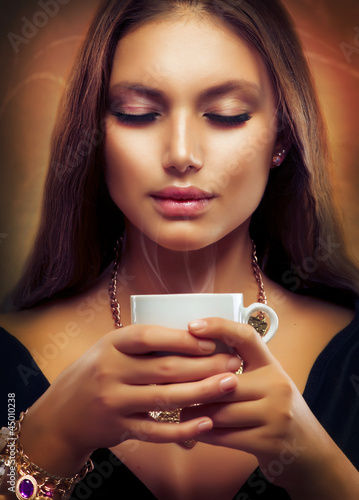 Photo: Coffee. Beautiful Girl Drinking Tea or Coffee Coffee. Beautiful Girl Drinking Tea or Coffee