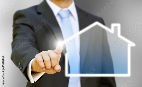 Photo: Businessman drawing his house with his finger Businessman drawing his house with his finger