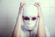 Bandaged victim of genetic experiment embracing herself