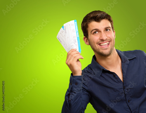 Photo: A Young Man Holding Tickets A Young Man Holding Tickets