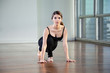 Woman Practicing Yoga At Gym