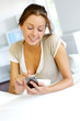Young woman sending short message with telephone