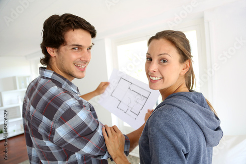 Photo: New property owners looking at home blueprint New property owners looking at home blueprint