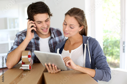 Photo: Couple calling transport company to move in new house Couple calling transport company to move in new house
