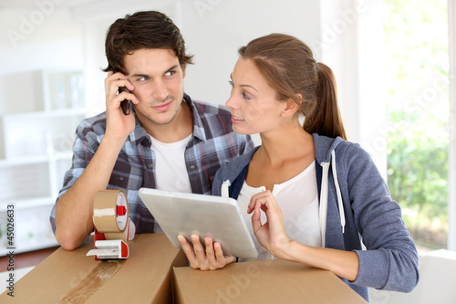 Photo: Couple calling transport company to move in new house Couple calling transport company to move in new house
