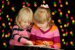 Two girls read book of tales on the Cristmas Eve