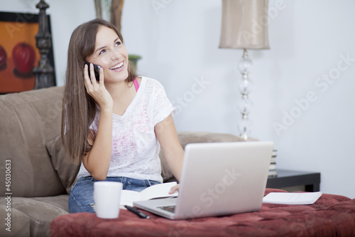 Photo: Happy woman working at home and talking to a customer Happy woman working at home and talking to a customer