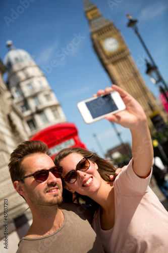 Photo: Tourists taking a picture in London Tourists taking a picture in London
