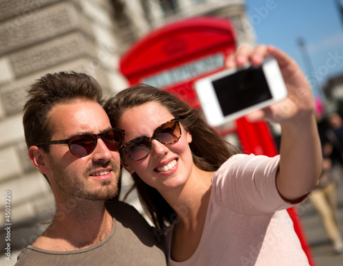 Photo: Couple taking a self portrait Couple taking a self portrait