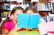 Photo: Two girls reading a book Two girls reading a book