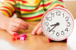 Little cute baby with clock