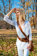Foto: Woman looks askance at the autumn colored park Woman looks askance at the autumn colored park