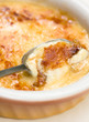 Broken Crema catalana in pan with spoon
