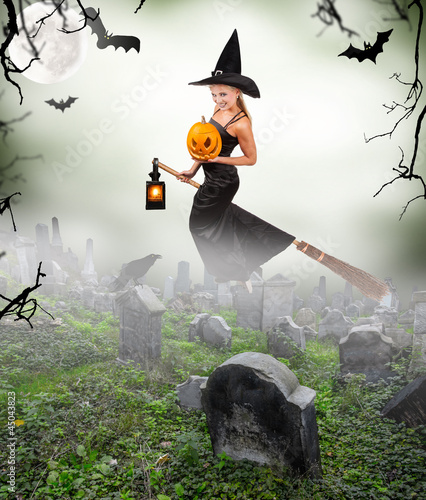 Photo: Beautiful sorceress flying on broom on graveyard Beautiful sorceress flying on broom on graveyard