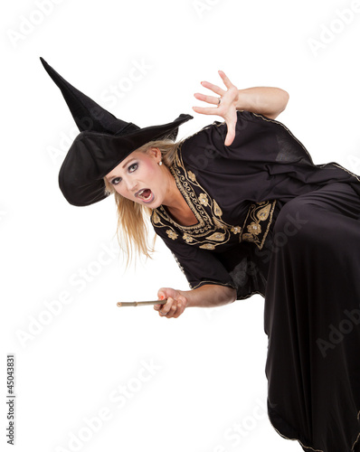 Photo: Scary sorceress casting a spell. isolated on white background Scary sorceress casting a spell. isolated on white background