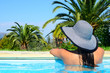 Beautiful woman enjoying sun at swimming pool