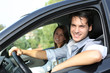 Cheerful couple driving car