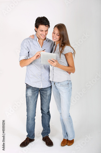 Photo: Young couple doing shopping on internet Young couple doing shopping on internet