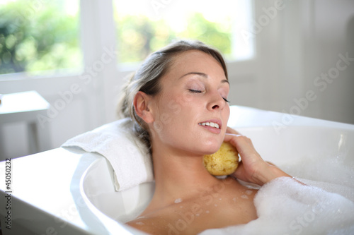 Photo: Beautiful woman relaxing in baththub Beautiful woman relaxing in baththub