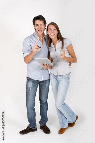 Photo: Young couple doing shopping on internet Young couple doing shopping on internet