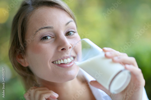 Photo: Portrait of healthy girl drinking milk Portrait of healthy girl drinking milk