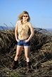 beautiful girl in shorts and hat on grapevine