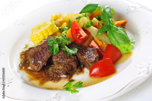 Photo: Traditional goulash or beef stew with vegetables and salad of fr Traditional goulash or beef stew with vegetables and salad of fr