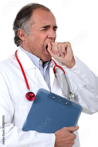 Photo: Tired doctor yawning Tired doctor yawning