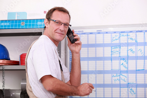 Photo: worker planning on a board worker planning on a board