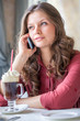 A woman in restaurant is talking to mobile phone