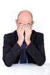 Tired man rubbing his eyes