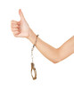 woman hand with handcuffs and thumb up