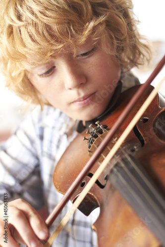 Photo: Boy Practicing Violin At Home Boy Practicing Violin At Home
