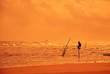 Photo: Lone fisherman in the ocean at sunset background in Sri Lanka. Lone fisherman in the ocean at sunset background in Sri Lanka.